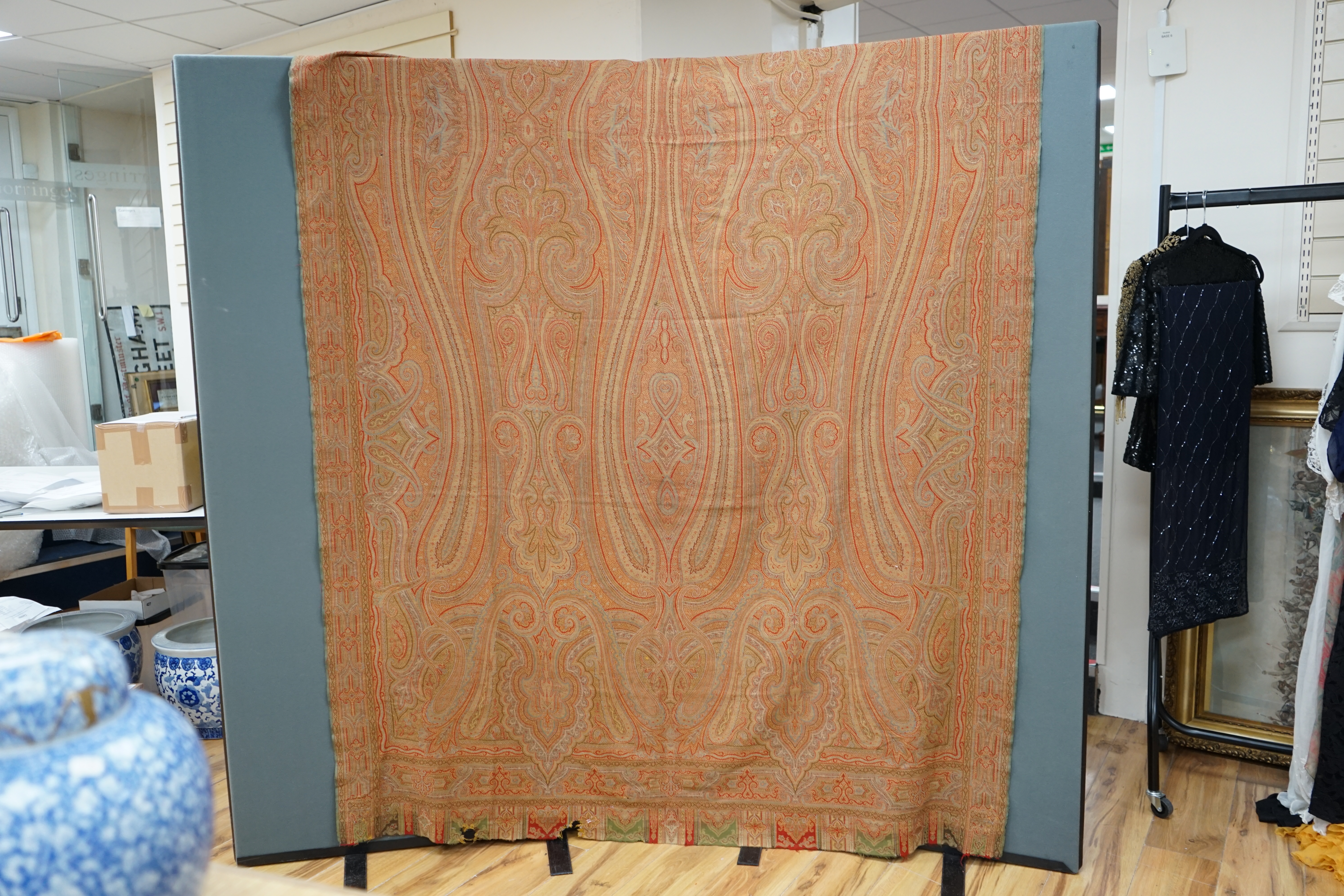 A Victorian wool woven Paisley shawl, designed with a large central tear drop, with intricate paisley design, woven in reds, blues, greens and yellows, the pattern from centre to left and centre to right the same, 160cm